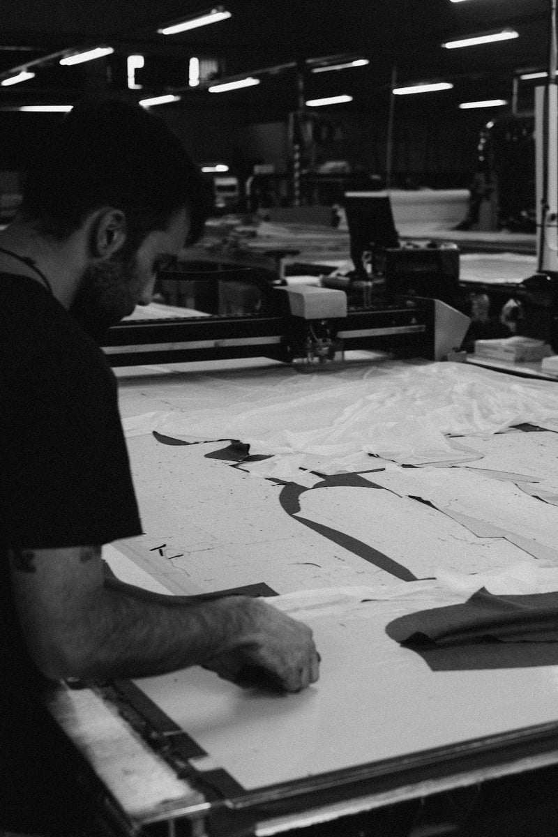 Cutter arranging cut pieces on a long table