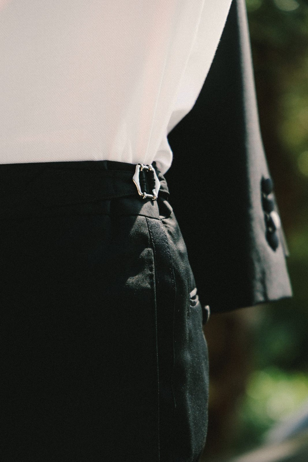 Side adjuster on tuxedo trousers