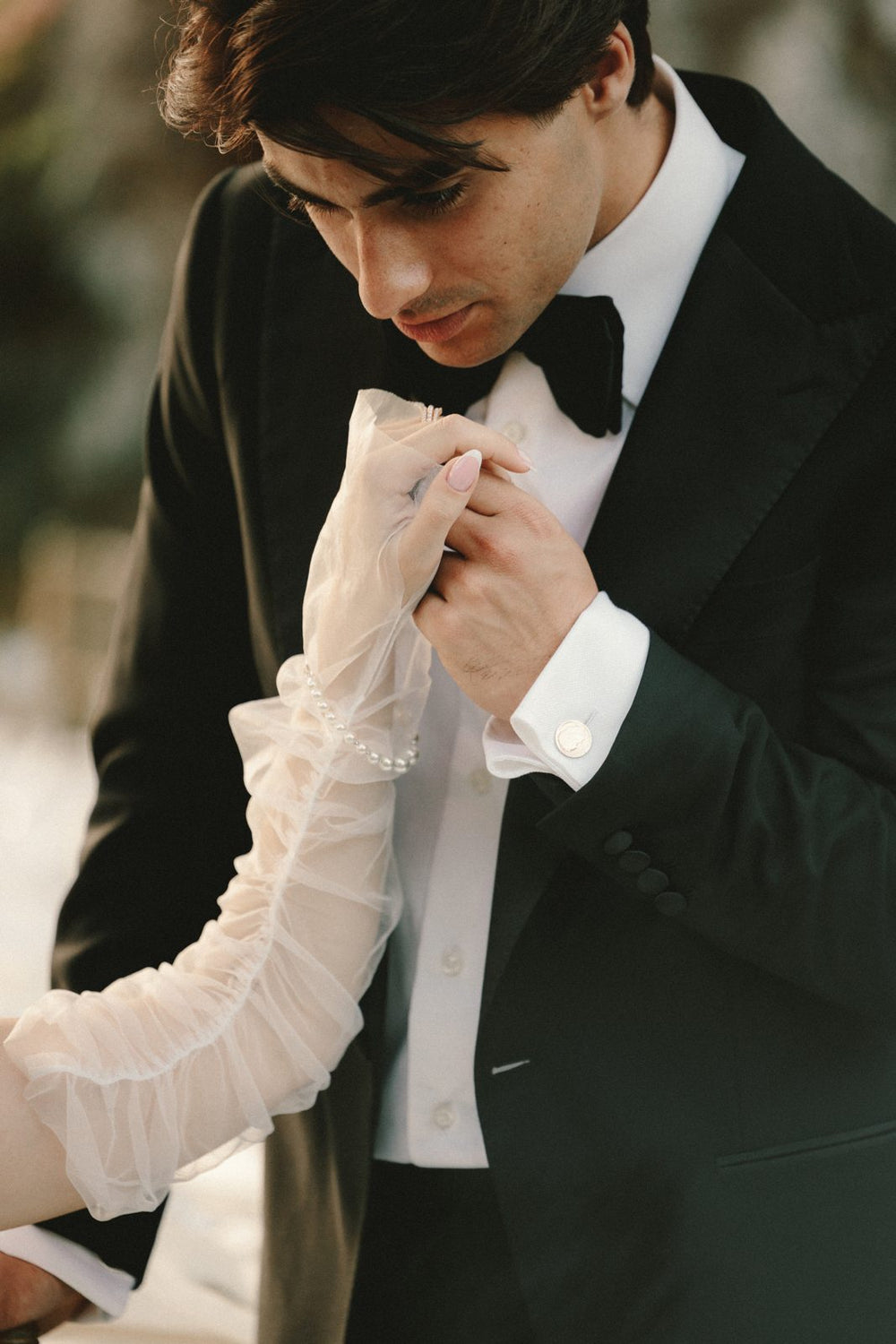 Groom in a black tuxedo with satin peak lapels
