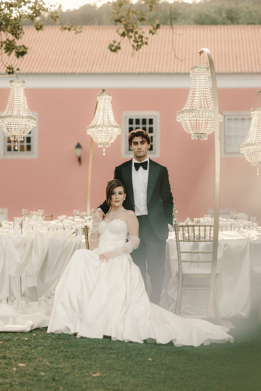 Groom in a tuxedo with the bride at a candlelit dinner