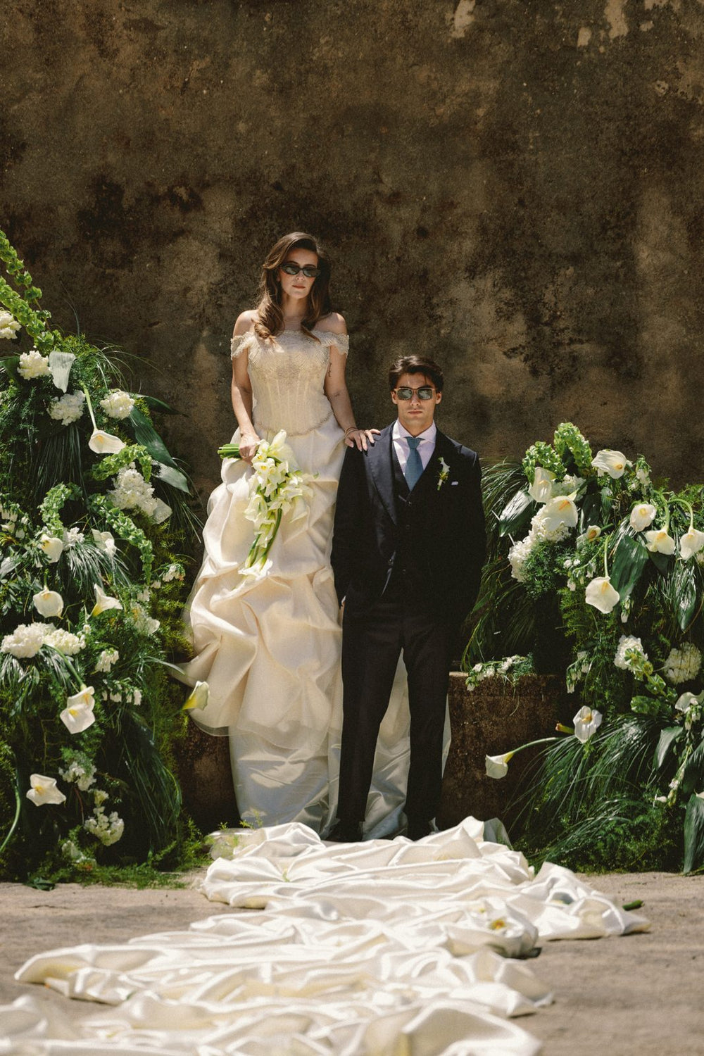 Bride and groom under a flower arch