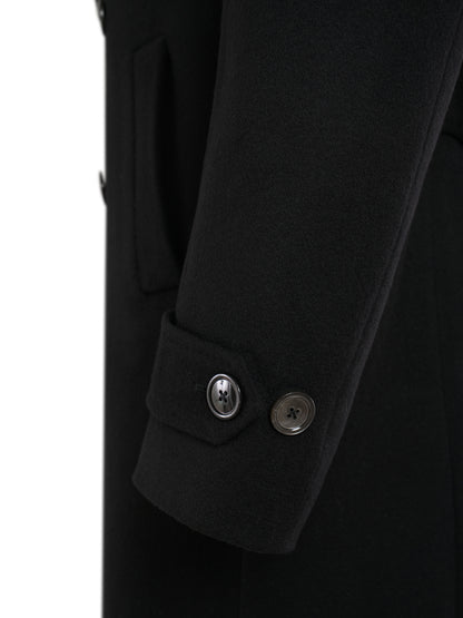 Buttoned sleeve tab of the black double-breasted overcoat
