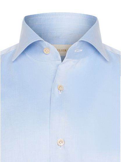 Model wearing ATELIER 23 light blue shirt — refined classic look